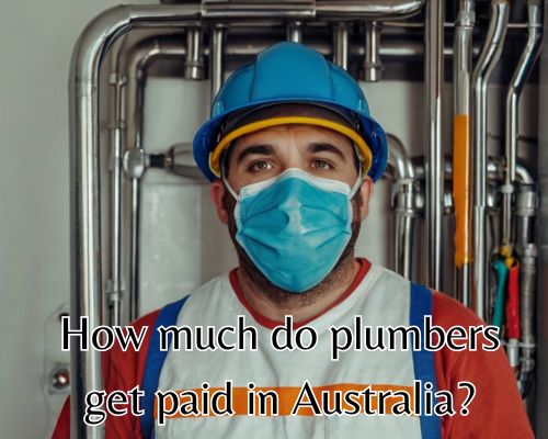 A plumber is working in a narrow utility room.